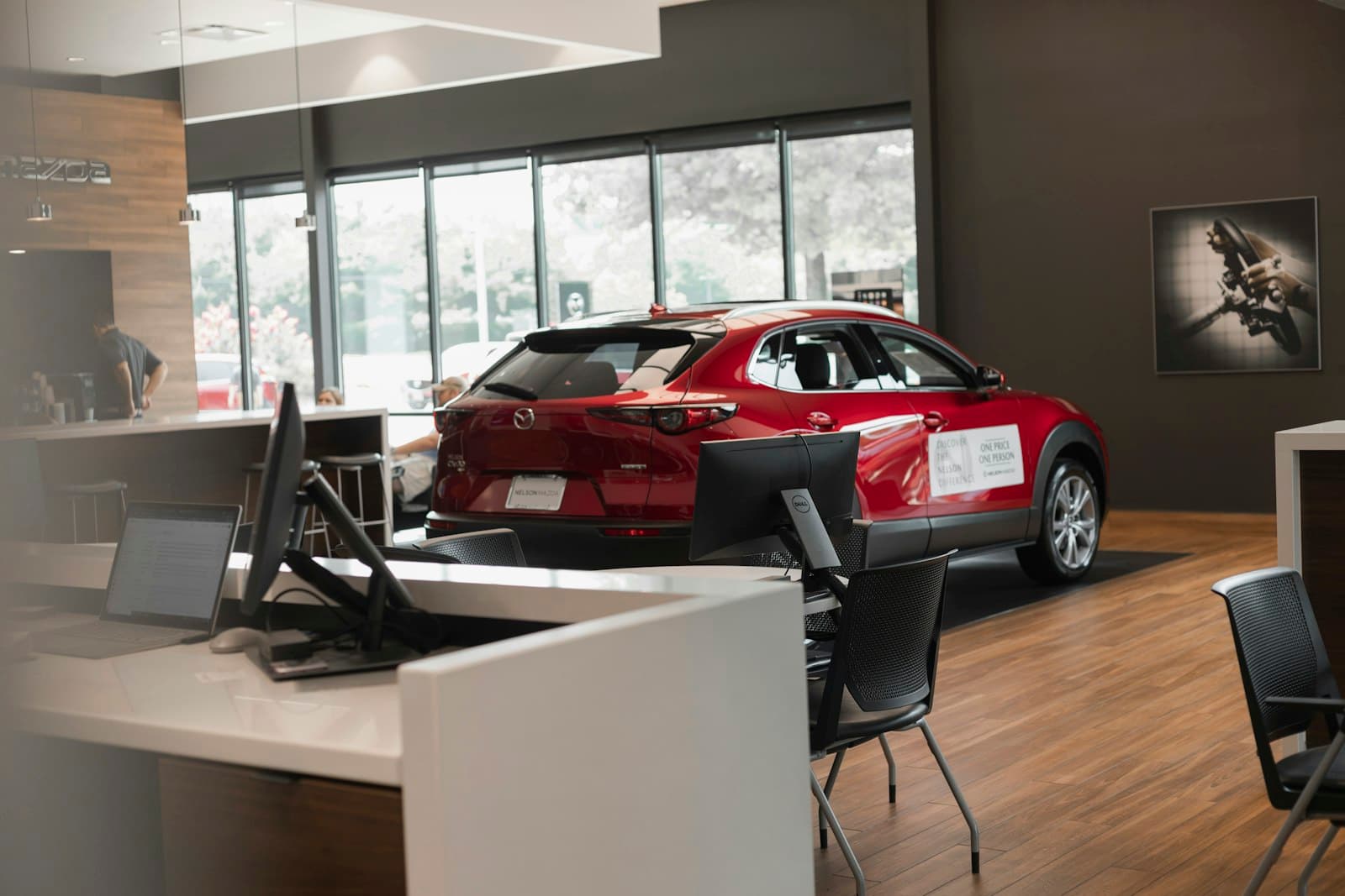 Car showroom floor with vehicles on display, representing automotive dealership advertising