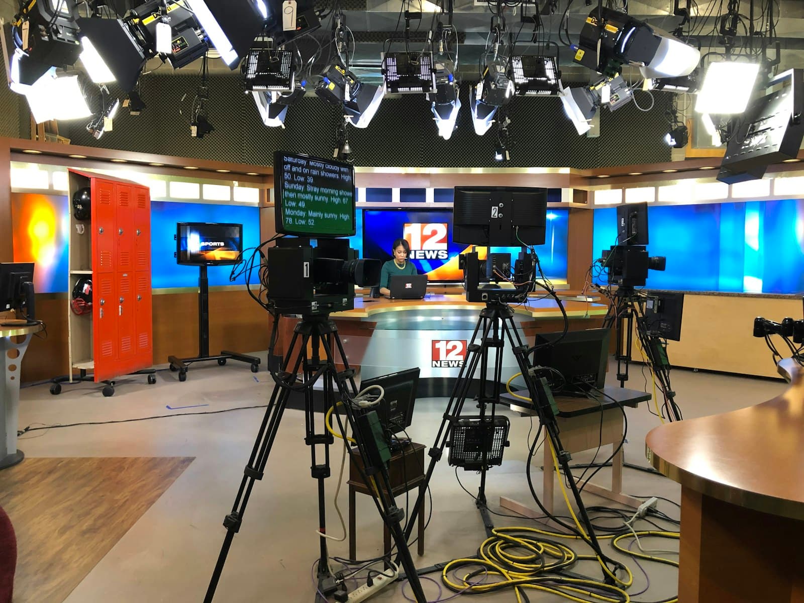 Television news studio set, representing network and streaming promo voiceover