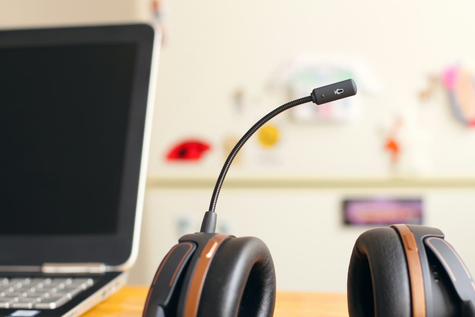 Headset resting beside a laptop, representing IVR and on-hold telephony voiceover